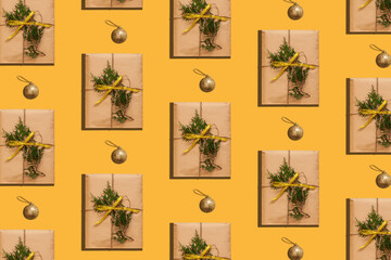Trendy Christmas pattern made with paper gift box photo on pastel yellow background. Minimal zero waste New Year concept. Greeting card wallpaper mockup. Winter holidays creative eco friendly backdrop