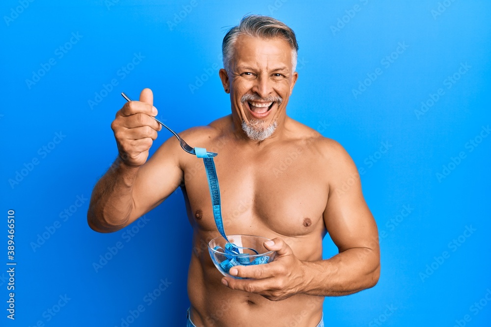 Sticker middle age grey-haired man shirtless eating measure meter doing diet for weight loss smiling and lau