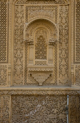 Fototapeta na wymiar Carved ornament on the walls in Jaisalmer, Sand rock texture, background