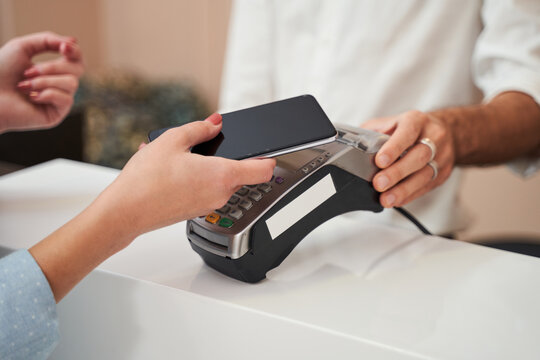 Woman paying with card contactless i