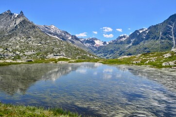 Fototapeta na wymiar Lac Perrin and view of the d'Ambin valley and mountains, La Vanoise National park, France