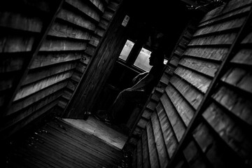 Low Key Silhouette Of Man In Wooden Bird Hide