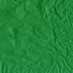 Fototapeta premium Green vintage and old looking crumpled paper background. Retro cardboard texture. Grunge paper for drawing. Ancient book page. Present wrapping.