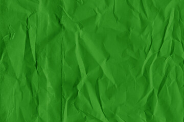 Green vintage and old looking crumpled paper background. Retro cardboard texture. Grunge paper for drawing. Ancient book page. Present wrapping.