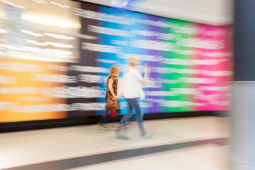 Two People Walking in Shop, Motion Blur