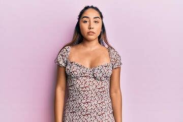 Young latin woman wearing casual clothes relaxed with serious expression on face. simple and natural looking at the camera.