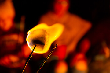 roasting a marshmallow around a campfire to make s'mores