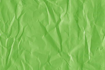 Green vintage and old looking crumpled paper background. Retro cardboard texture. Grunge paper for drawing. Ancient book page. Present wrapping.
