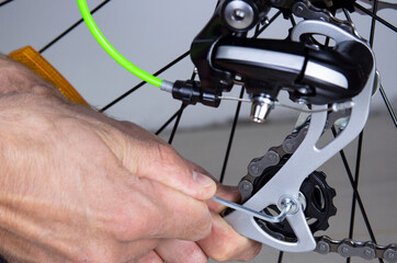 Fototapeta na wymiar Adjustment and repair of bicycle mechanisms. Transport repair concept