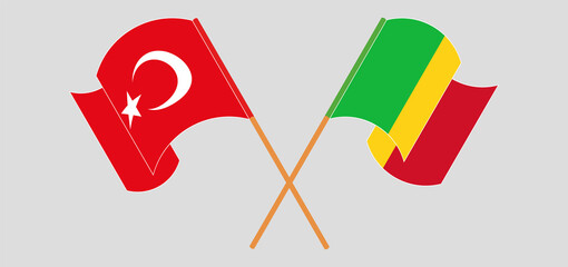 Crossed and waving flags of Mali and Turkey