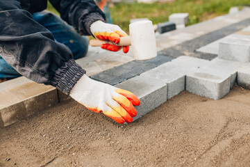 Laying stone tiles outdoors - pavers for footpaths - professional bricklaying