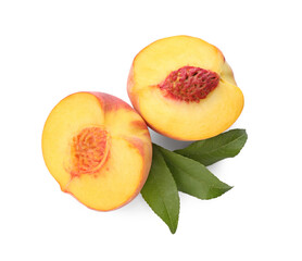 Halves of ripe peach with leaves on white background, top view
