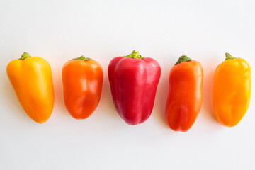 Red pepper, orange pepper and yellow pepper on white background