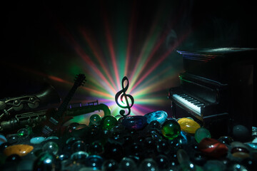 Musical symbol treble clef stainless steel miniature with colorful toned light on foggy background....