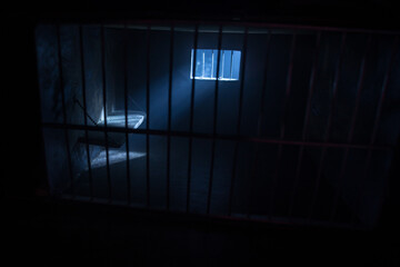 Jail or prison cell. Old grunge prison miniature. Dark prison interior creative decoration. Empty cell. Selective focus Obsolete gray grunge concrete room.