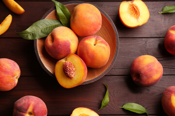 Fresh sweet peaches on wooden table, flat lay