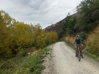 Biking on the Twin Rivers Trail toward the Shotover Bridge, Queenstown Area, South Island, New Zealand