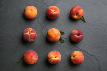 Fresh sweet peaches on black table, flat lay