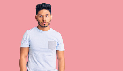 Handsome latin american young man wearing casual clothes skeptic and nervous, frowning upset because of problem. negative person.