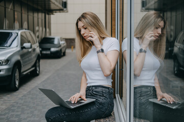 Fototapeta na wymiar Earn extra money, Side hustle, money making, turning hobbies into cash, Gig economy, digital nomad. Young woman, student with laptop and smartphone working outside