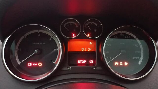Handheld Shot Car Warning Light Symbols and Indicators on Car Dashboard 