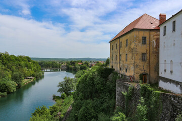 Fototapeta na wymiar Slunj/ Croatia-August 8th, 2018: Beautiful old castle, towering above Korana river, surrounded by green forest near the city of Karlovac