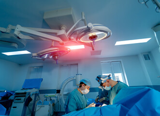 Surgery in hospital. Specialists providing operation with modern technology equipment in hospital....