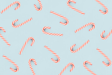 Christmas composition. Pattern made of red and white candies on blue background. Christmas, winter, new year concept. Minimal style. Flat lay, top view.