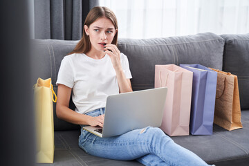 Woman puzzled while sitting at the sofa