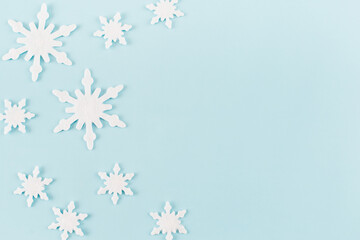 Christmas composition. Snowflakes on blue background. Christmas, winter, new year concept. Minimal style. Flat lay, top view, copy space.