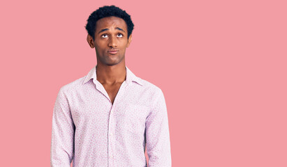 African handsome man wearing casual pink shirt depressed and worry for distress, crying angry and afraid. sad expression.
