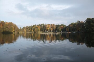 Pier and holiday resort on the lake by the forest in beautiful autumn scenery. Lapino Lake, Kashubia, Poland
