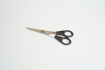 stainless steel scissors with black handle laid