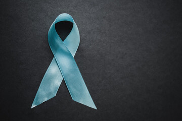 Green ribbon HIV, AIDS on gray background