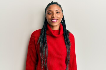 African american woman wearing casual winter sweater with a happy and cool smile on face. lucky...