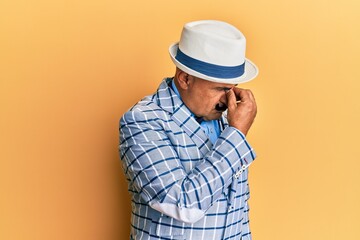 Mature middle east man with mustache wearing vintage and elegant fashion style tired rubbing nose and eyes feeling fatigue and headache. stress and frustration concept.
