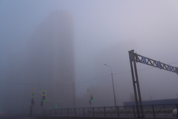 The fog in the city of St. Petersburg in the morning hides the houses and the road. Background