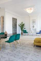 modern and very stylish interior design of large studio apartment with fashionable furniture with gold elements. very light and bright room with big windows