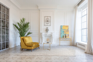 modern and very stylish interior design of large studio apartment with fashionable furniture with gold elements. very light and bright room with big windows