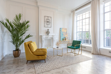 modern and very stylish interior design of large studio apartment with fashionable furniture with gold elements. very light and bright room with big windows