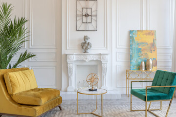 modern and very stylish interior design of large studio apartment with fashionable furniture with gold elements. very light and bright room with big windows