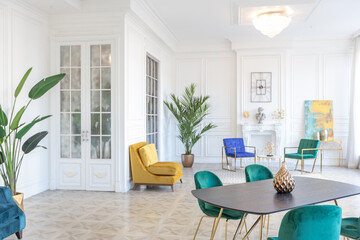 modern and very stylish interior design of large studio apartment with fashionable furniture with gold elements. very light and bright room with big windows