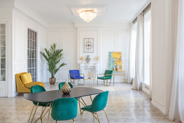 modern and very stylish interior design of large studio apartment with fashionable furniture with gold elements. very light and bright room with big windows