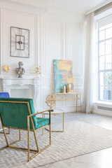 modern and very stylish interior design of large studio apartment with fashionable furniture with gold elements. very light and bright room with big windows