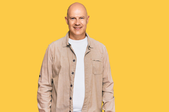 Middle age bald man wearing casual clothes with a happy and cool smile on face. lucky person.