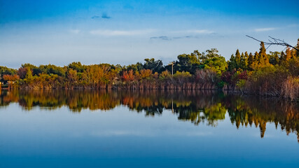Blue sky, blue lake, fall foliage reflection in lake