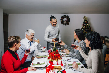 mexican family drinking wine on Christmas eve dinner