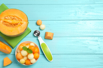 Melon balls and mint in bowl on light blue table, flat lay. Space for text