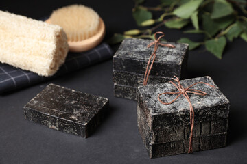 Natural tar soap on black table, closeup