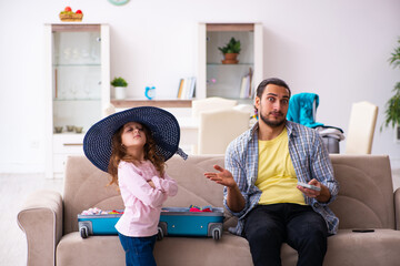 Young man and his small daughter preparing for the trip